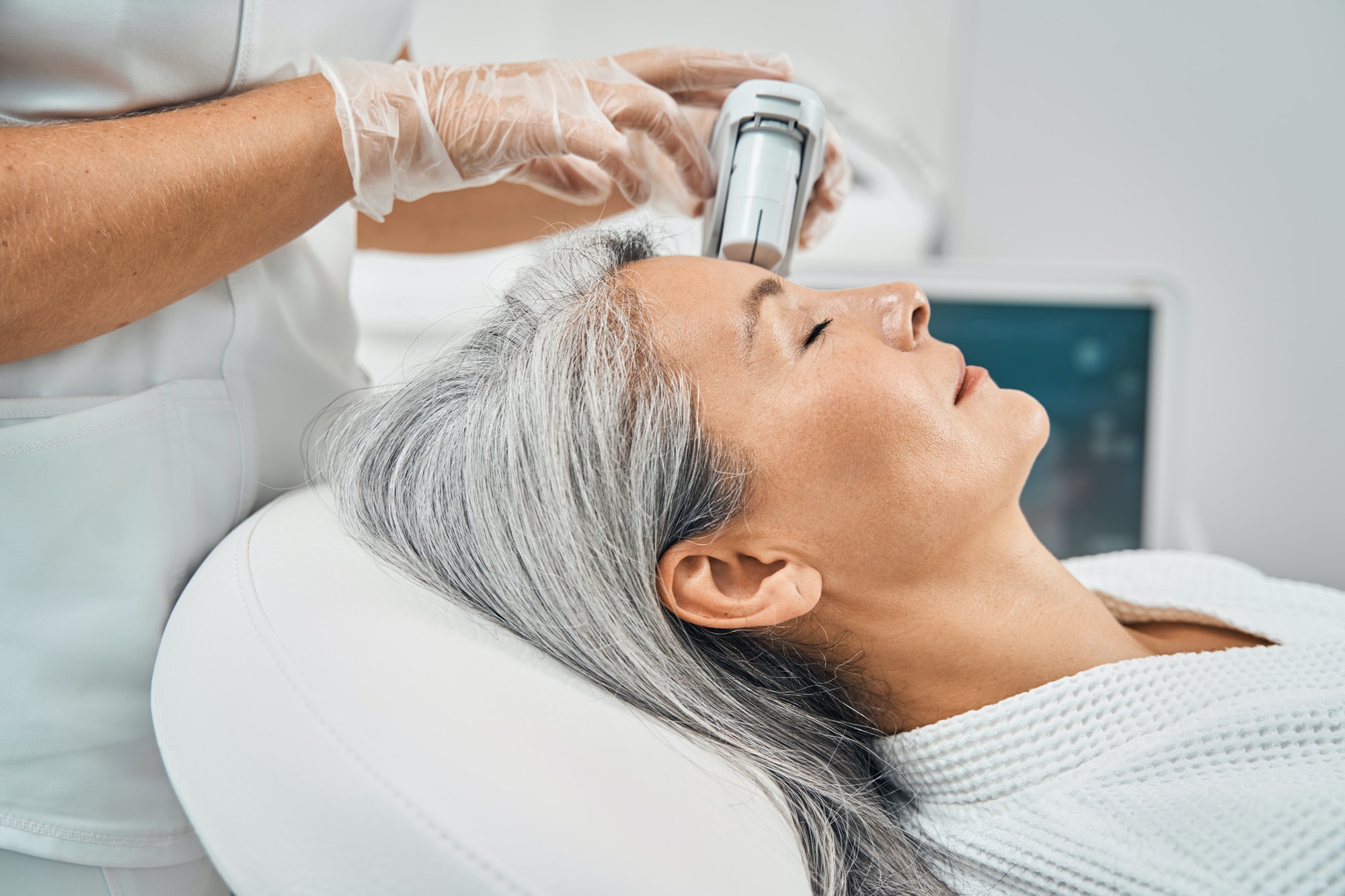 aged-female-person-doing-face-lifting-massage