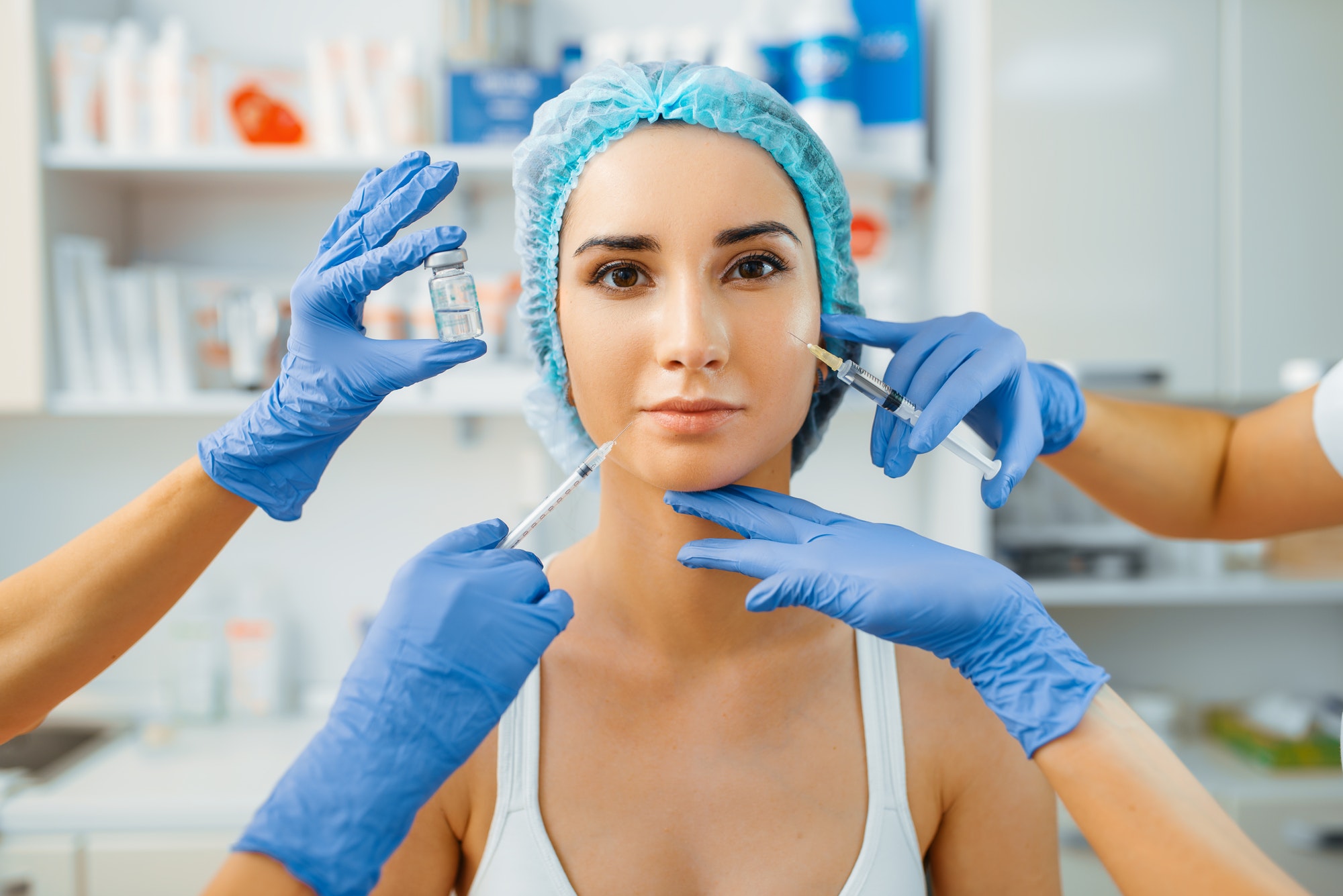 cosmetician-hands-with-botox-and-female-patient